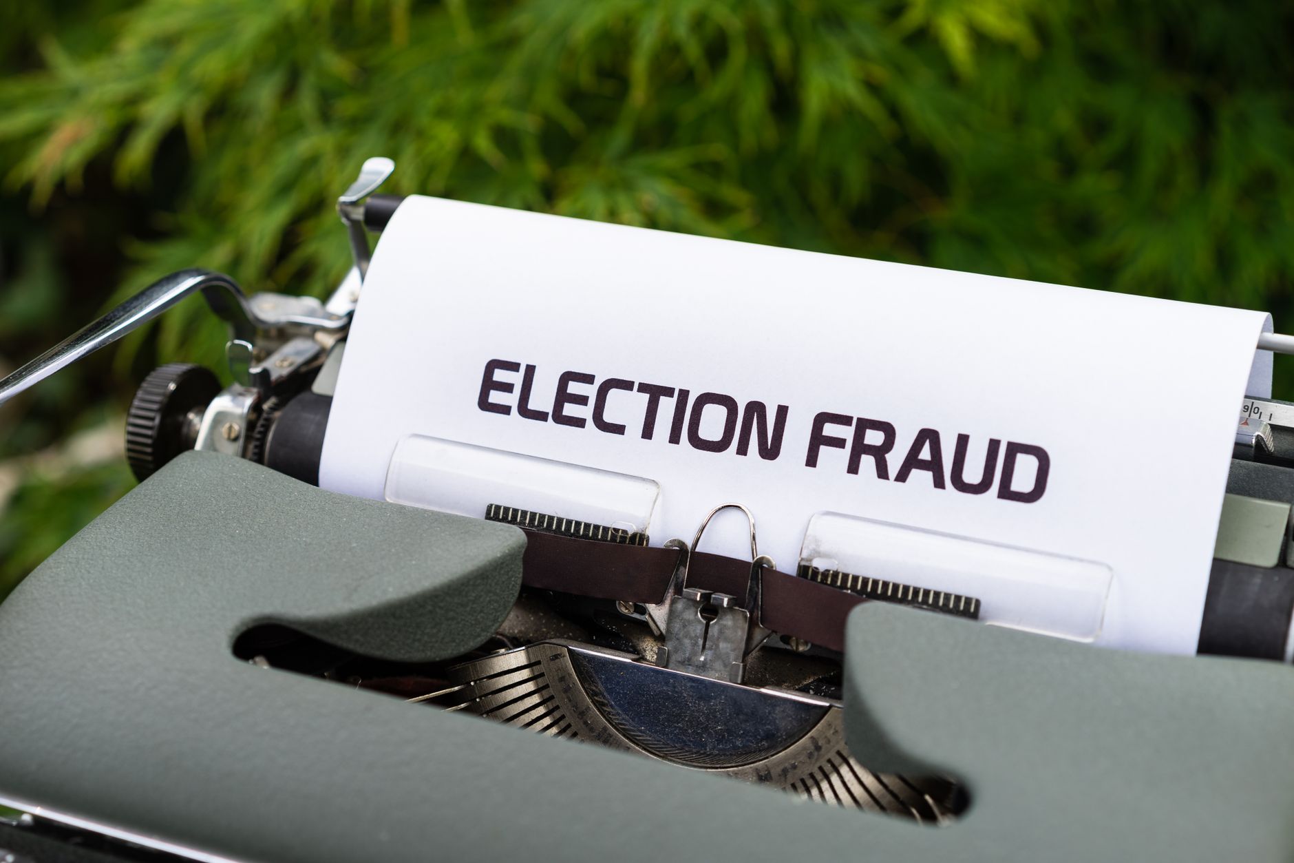 A close up of a vintage typewriter with a paper displaying &amp;#39;Election Fraud&amp;#39;. Ideal for themes of politics and nostalgia.
