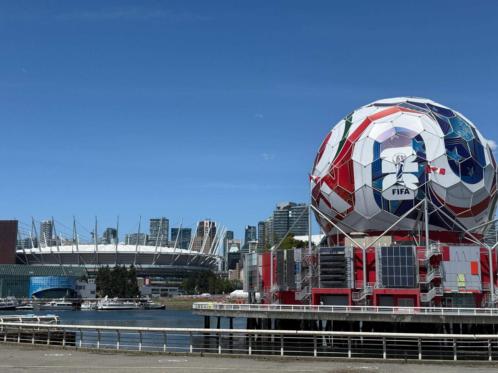 Iconic FIFA soccer ball and Vancouver stadium, showcasing urban sports architecture.