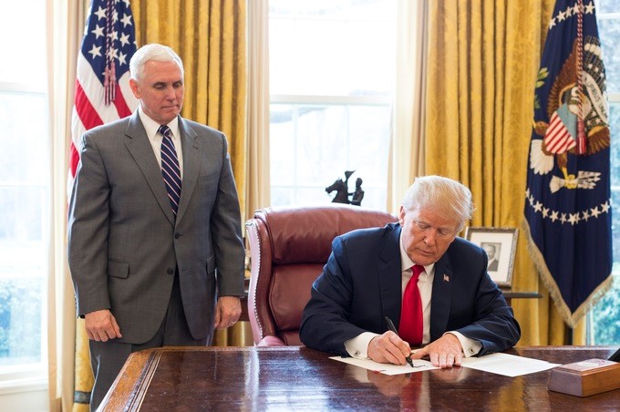 President Donald Trump signs an Executive Order in the Oval Office