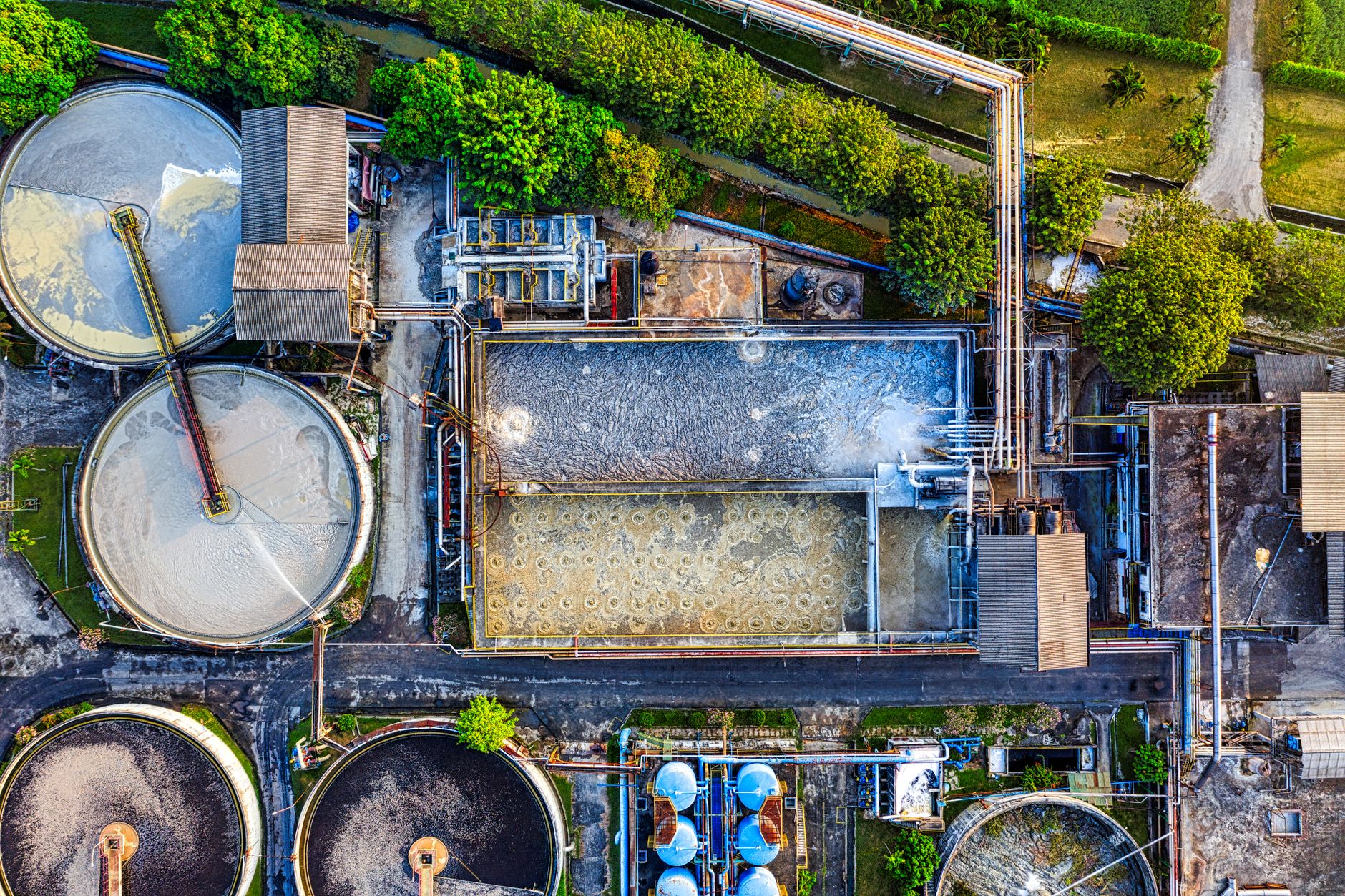 Top down view of an industrial waste management facility in Serang, Indonesia, highlighting various processing tanks.