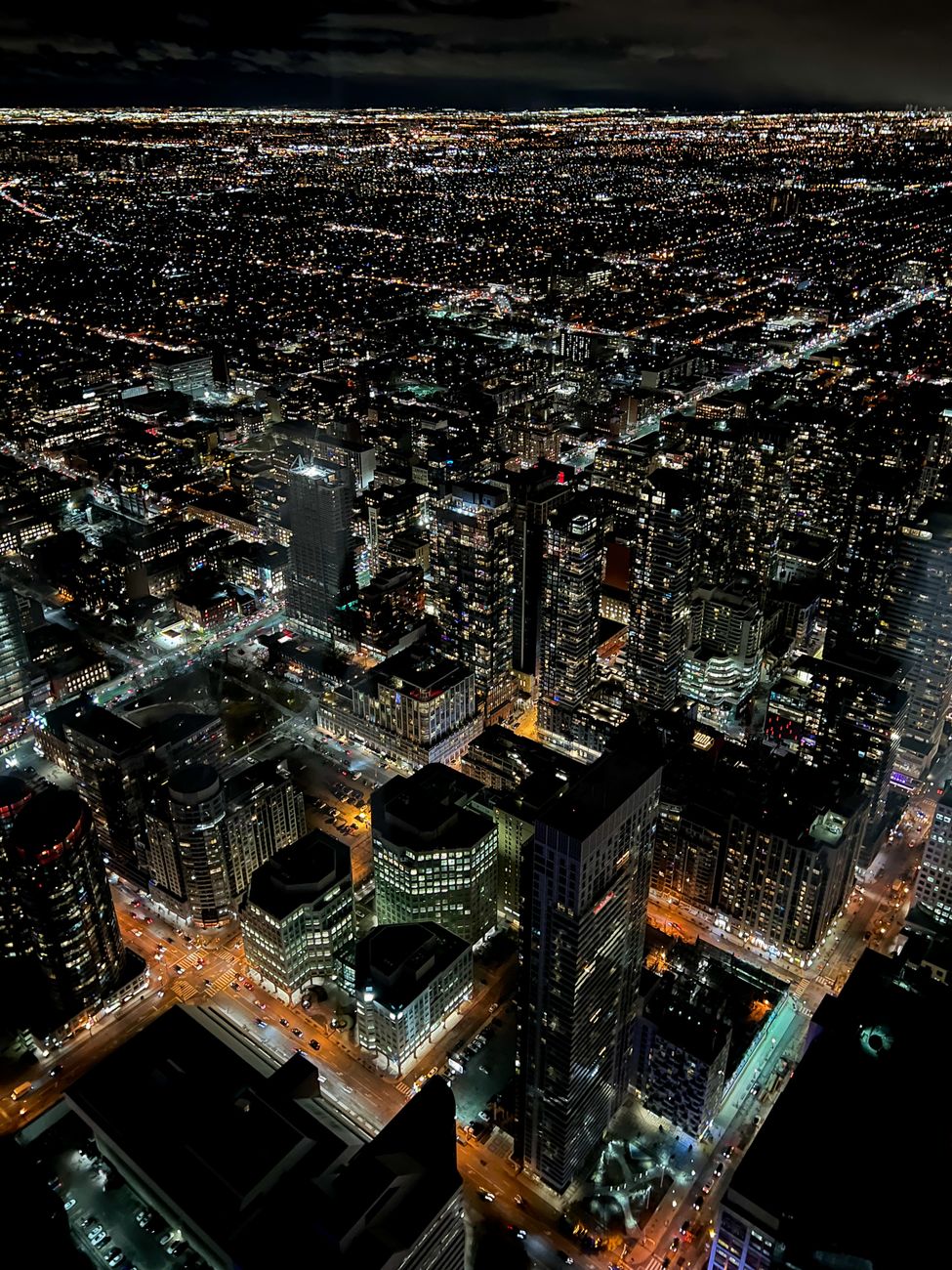 Stunning aerial view of Toronto's illuminated skyline at night, showcasing urban life.