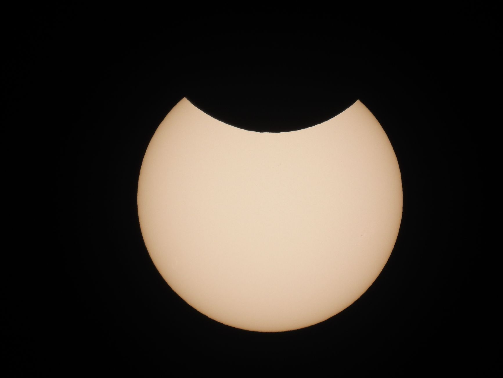Captivating view of a partial solar eclipse with the sun partially obscured by the moon.